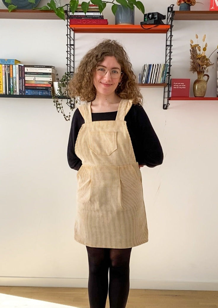 Picture of Leen posing in the Billie pinafore and smiling.