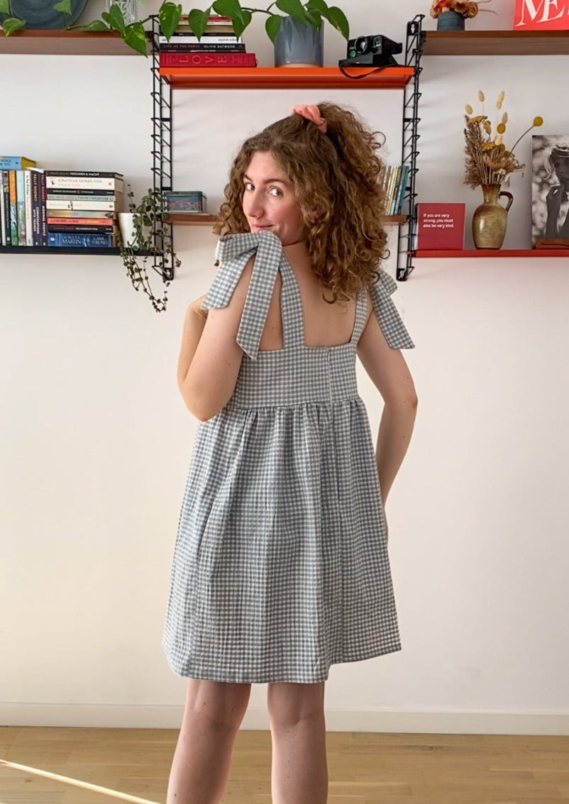 Back profile picture of Leen, a twenty something white woman, posing in the Alice dress..