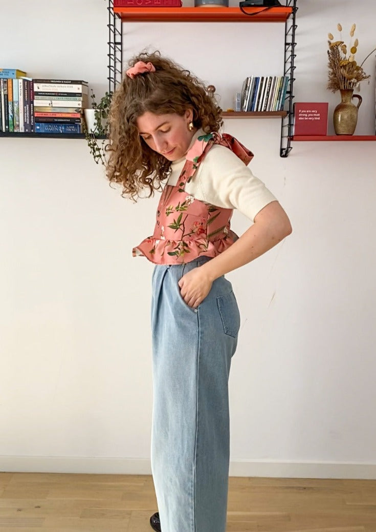 Side profile picture of Leen, a twenty something white woman, posing in the Meadow top.